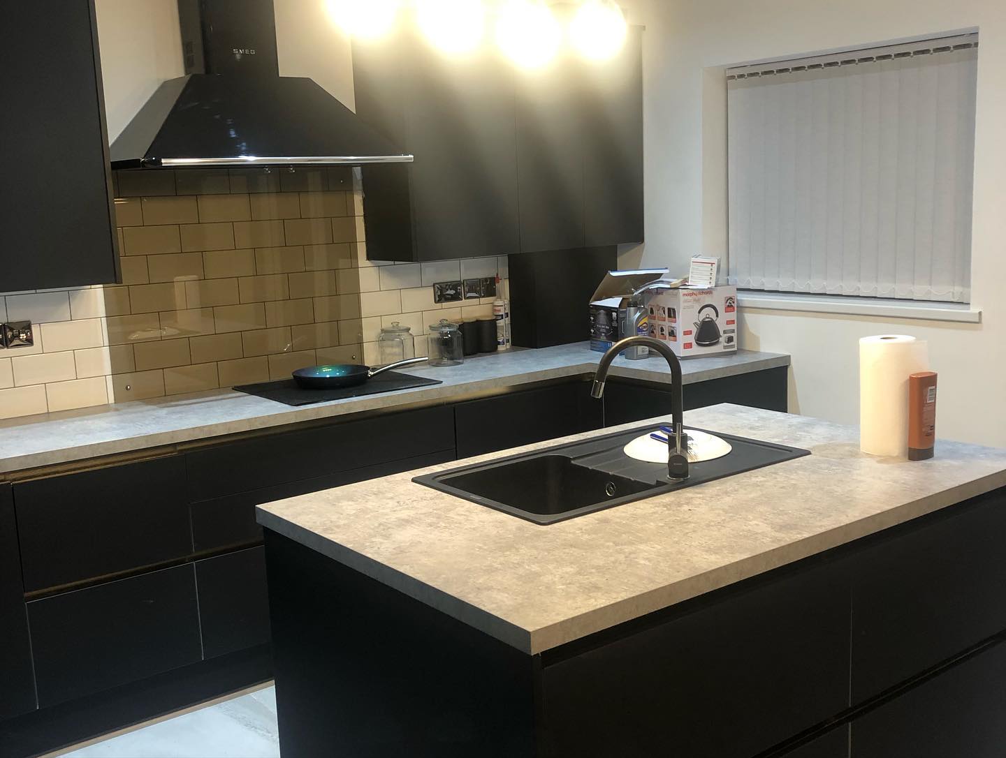 Black fitted kitchen cabinetry and island