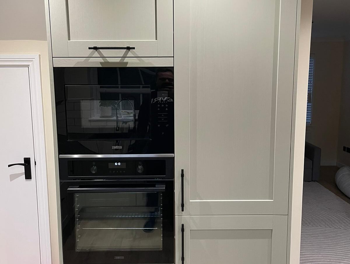 Detailed fitted cabinetry with coordinated appliance housing